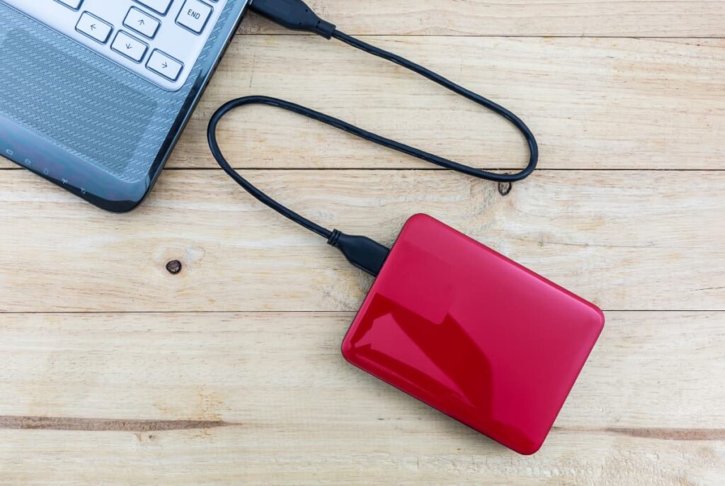 An external hard drive connected to a laptop as a backup storage device