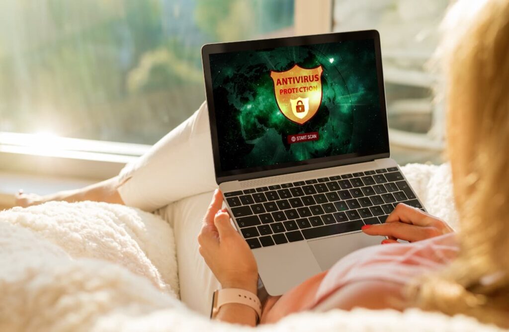 A woman using a laptop antivirus installed at home