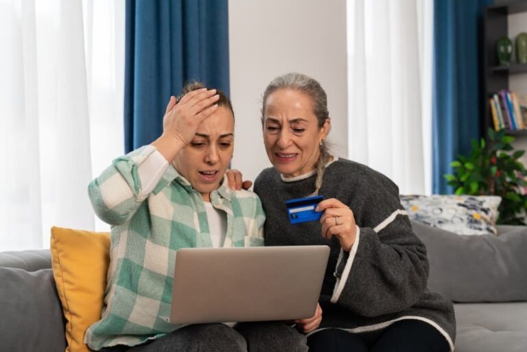 Two women realizing they were scammed online during a humanitarian crisis