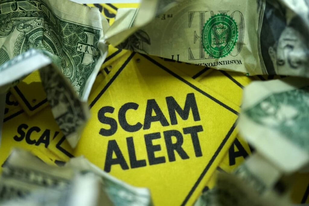 Image of a word “scam alert” to protect people from earthquake relief scams