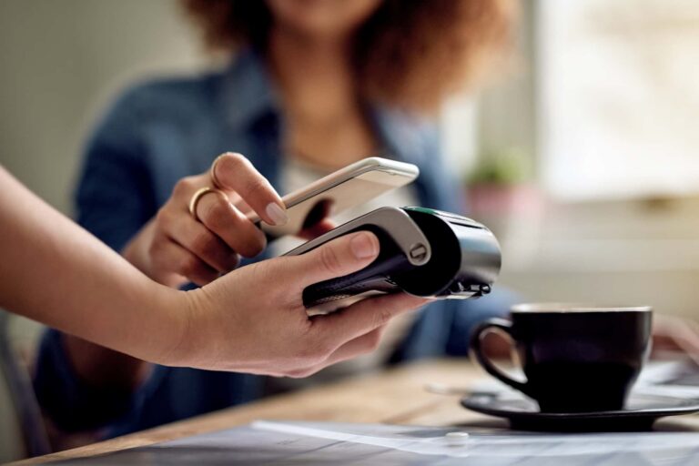 Tap-to-pay process showing a device held close to a payment terminal to complete a fast, contactless transaction.
