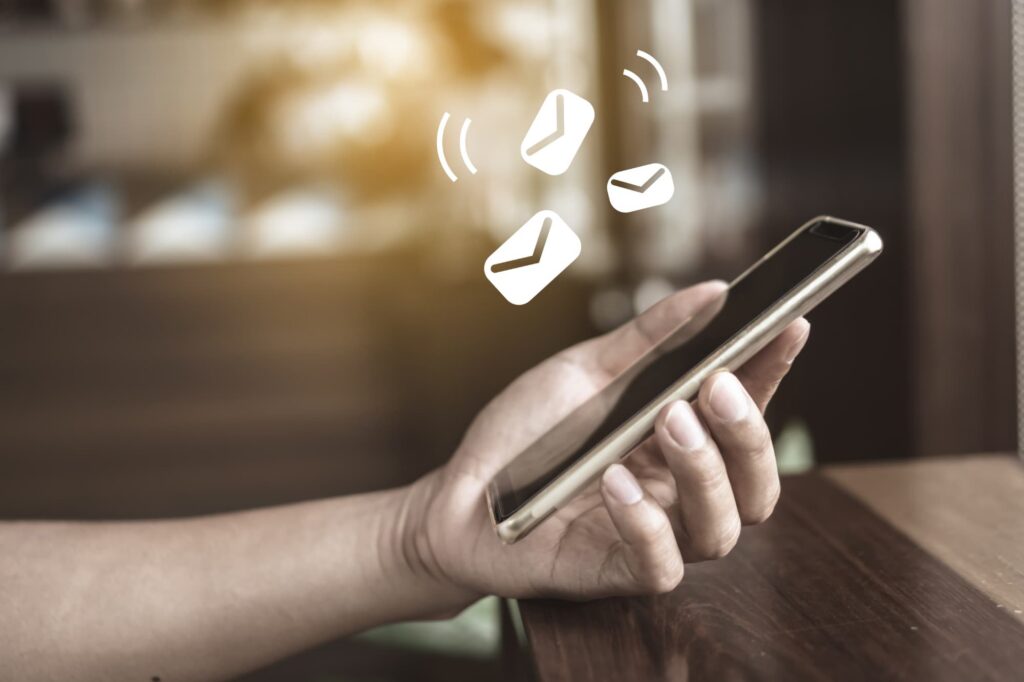 Smartphone screen displaying instant notifications for digital wallet purchases to detect unauthorized charges quickly.