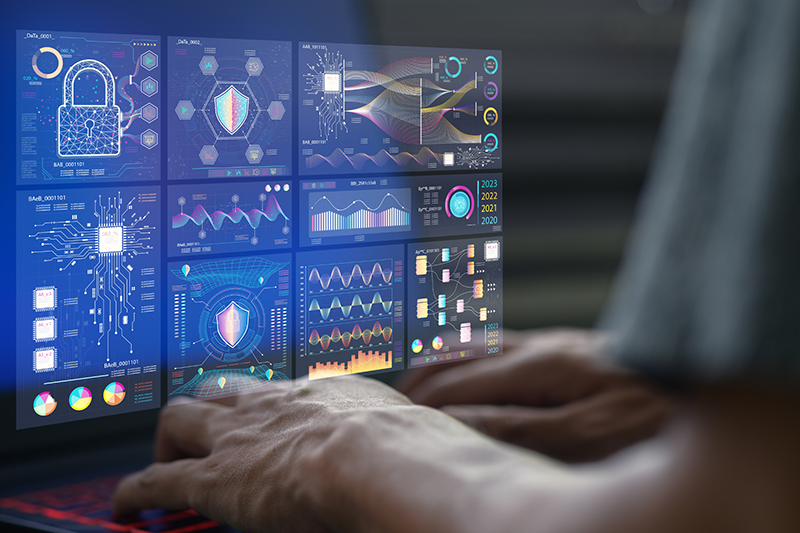 Confident professional working at a workstation with a security monitoring dashboard