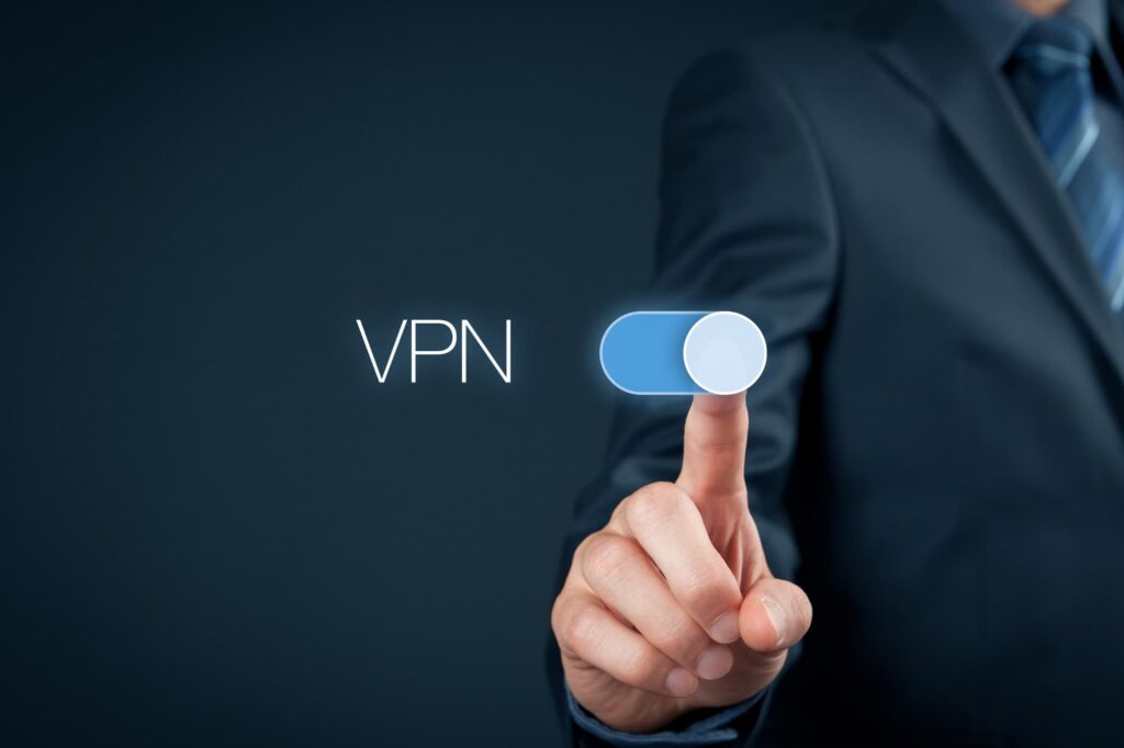 A person turning on a VPN connection, where their real IP address is hidden and replaced with one from a VPN server.