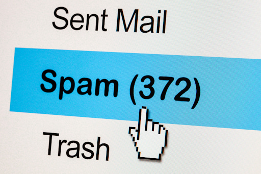 Illustration showing an email being flagged by a spam filter, highlighting how legitimate business emails can be mistakenly marked as spam.