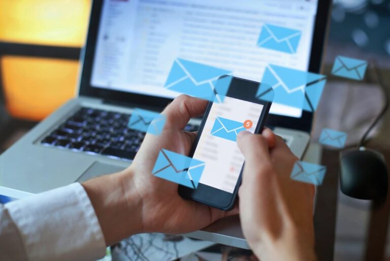 A phone and laptop displaying emails unread