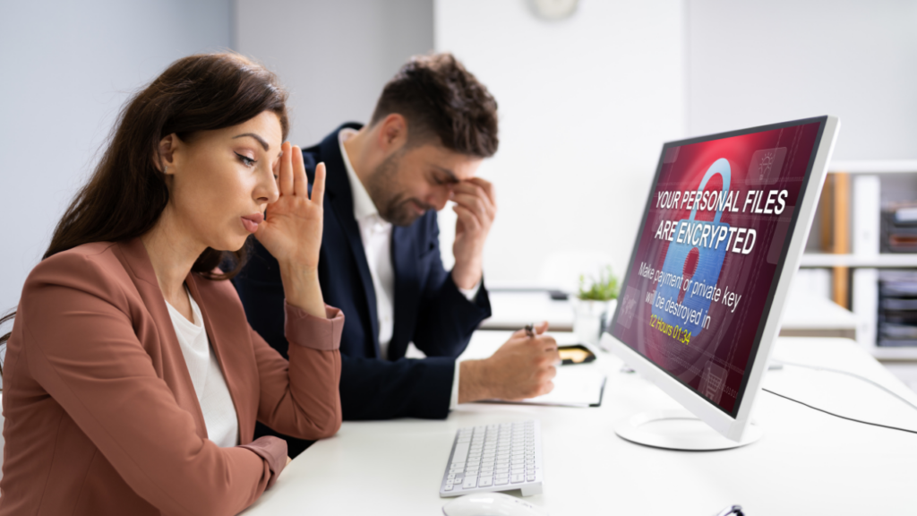 A man and woman looking worried because of an evil twin attack on their computer
