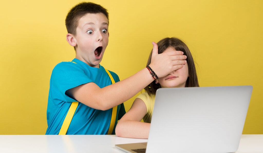 Brother covering sister's eyes while on internet