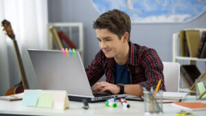 Teen boy on his laptop.