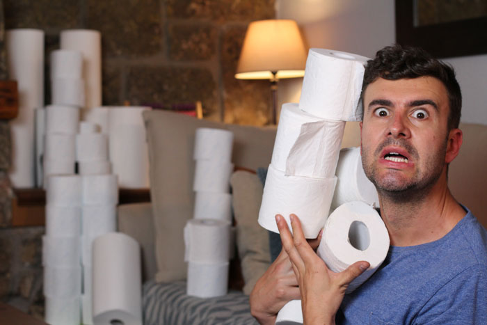 Man stocking up on toilet paper