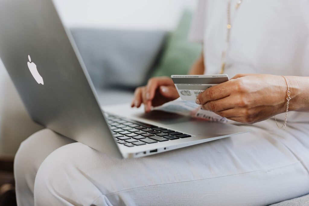 Individual entering card details to buy a product online.