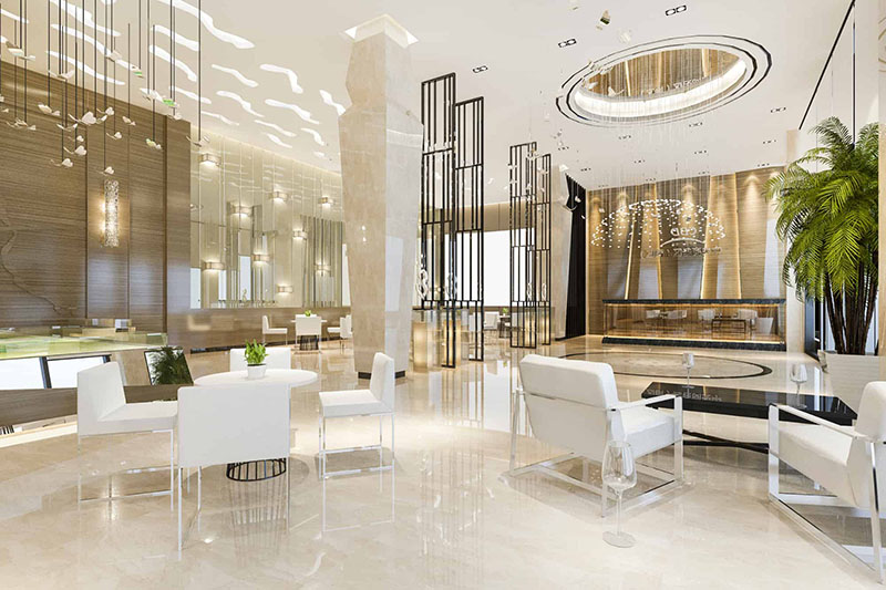 Spacious hotel lobby with seating areas, a reception desk, modern décor, and available Wi-Fi