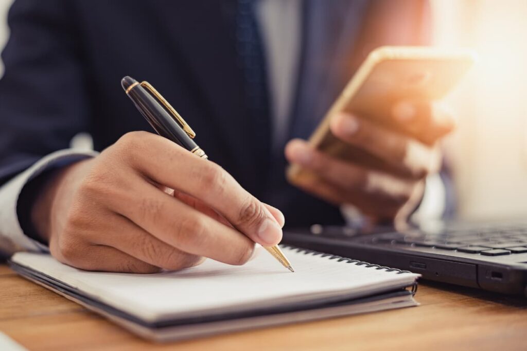 Person holding phone with checklist for opting out of data tracking
