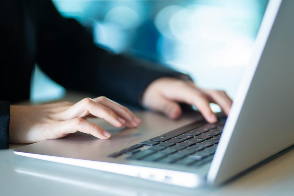 Hands holding a laptop while locating the private IP address in system settings.