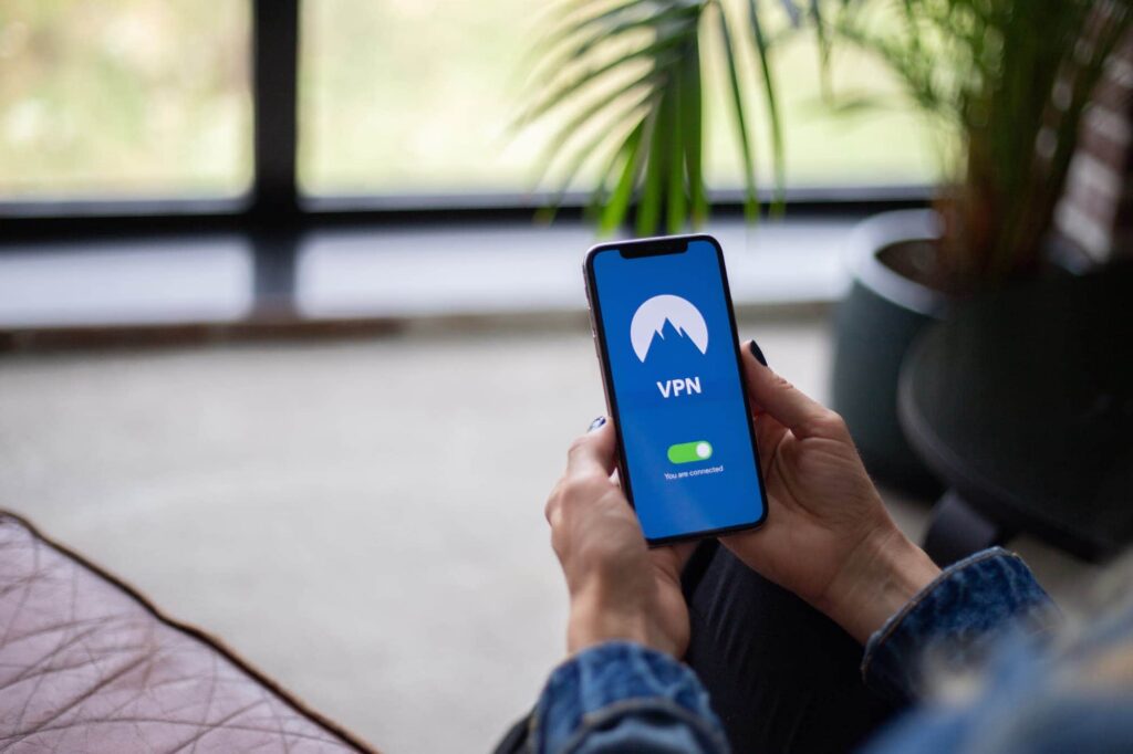 Smartphone with VPN enabled showing a secure connection icon while browsing on a public network for an encrypted and private internet access.