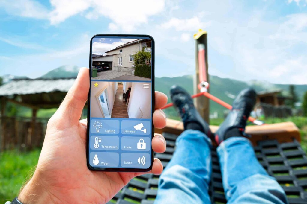 Man relaxing in a hammock while monitoring home CCTV security footage on a mobile.