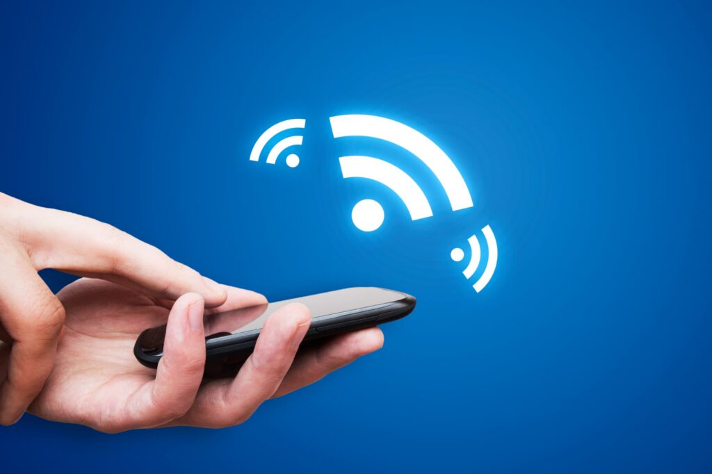 Hand holding a smartphone with NFC technology.